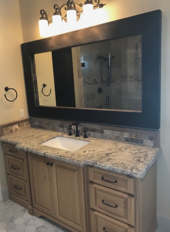 Same bathroom visualized with oak cabinets and marble hex floor